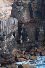 Canvas Print - ladder on the rock cliff around the coastline.