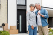 © LIGHTFIELD STUDIOS - mature man holding keys of new house and hugging smiling woman