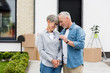 © LIGHTFIELD STUDIOS - mature man holding keys of new house and hugging smiling woman