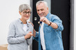 © LIGHTFIELD STUDIOS - mature man holding keys of new house and smiling woman looking at it