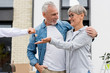 © LIGHTFIELD STUDIOS - cropped view of broker giving keys of new house to smiling man and woman