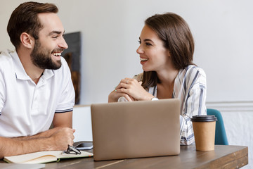 Poster - Smiling young couple working on a project