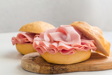 Canvas Print - Mortadella sandwich. Mortadella Bologna - a large italian sausage or luncheon  with meat. Tipycal italian bread - La Rosetta.