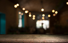 Empty Wood Table Top On Blur Light Gold Bokeh Of Cafe Restaurant In Dark Background