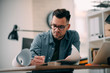© JustLife - Tired businessman in office. Young architect overworked.