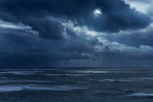 Dark Clouds In Overcast Sky Over Stormy Ocean, Devon, United Kingdom
