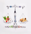 © Trevor Adeline/Caia Image - Still life concept healthy and unhealthy foods forming scale