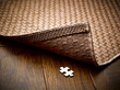 © Andy Roberts/Caia Image - Puzzle piece hidden underneath rug