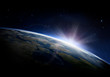 © Rana Dias/Caia Image - Sunlight ascending over Earth in outer space