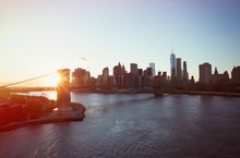 Cityscape View Of New York And Brooklyn Bridge At Sunset