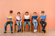© Pixel-Shot - Cute little children reading books on color background