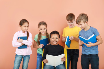 Sticker - Cute little children with books on color background