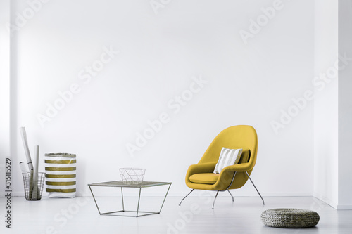 Fotomural Real photo of a minimalistic living room interior with a yellow armchair