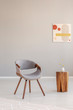 © Photographee.eu - Stylish grey wooden chair in empty living room interior with trendy wooden coffee table