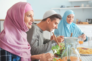 Wall Mural - Muslim family having dinner at home