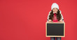 time for school holiday. winter shopping sales. announcement board. very profitable proposition. happy girl empty blackboard. copy space. useful information here. winter activity advertisement