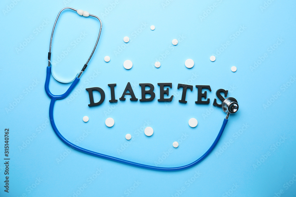 Stethoscope, pills and word DIABETES on color background