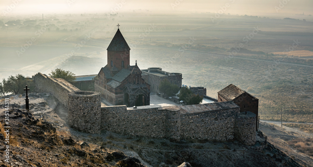 Khor Virap an Armenian monastery located in the Ararat plain in Armenia, near the closed border with Turkey, panoramic view during autumn sunrise with fog on background - obrazy, fototapety, plakaty 