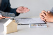 © Thitiphat - Real estate agent are presenting home loan and sending keys to customer after signing contract to buy house with approved property application form, Insurance Home concept
