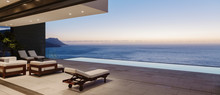 Modern Patio And Infinity Pool Overlooking Ocean At Sunset