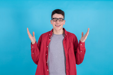 Wall Mural - young man with happy expression and open arms isolated on color background