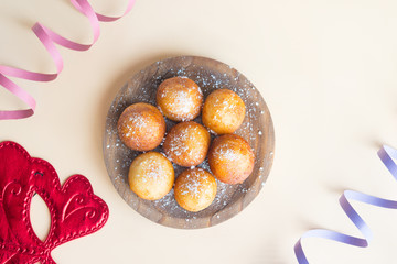 Carnival italian fritters in carnival on brown background