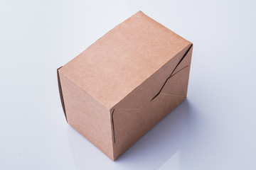 Wall Mural - Closed mail cardboard box. White isolated background.