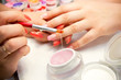 © staras - Master applies gel polish on nails in manicure salon