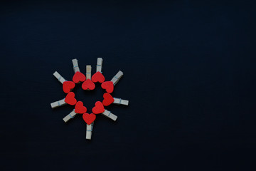  wooden hearts on a black background. Valentine's Day