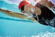Male Swimmer Swimming Underwater In Swimming Pool