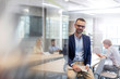 © Agnieszka Olek/Caia Image - Portrait businessman holding laptop in conference room