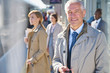 © Chris Ryan/Caia Image - Portrait smiling businessman on sunny train station platform