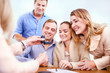 © Trevor Adeline/Caia Image - Jeweler showing diamond ring to couples in jewelry store