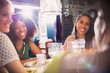 © Justin Pumfrey/Caia Image - Smiling women friends dining talking at restaurant table