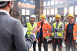 © Lukasz Olek/Caia Image - Steel workers listening to manager in meeting in factory