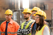 © Rafal Rodzoch/Caia Image - Steel workers listening in meeting in factory