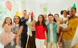 © Robert Daly/Caia Image - Portrait enthusiastic multi-ethnic multi-generation family celebrating party champagne party hats