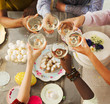 © Robert Daly/Caia Image - Overhead view friends toasting champagne glasses over Easter desserts