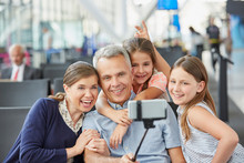 Family Taking Selfie With Selfie Stick At Airport