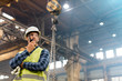 © Agnieszka Olek/Caia Image - Steel worker with walkie-talkie in factory