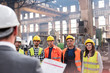 © Lukasz Olek/Caia Image - Steel workers listening to manager in meeting in factory