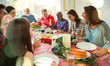 © Robert Daly/Caia Image - Laughing multi-ethnic family enjoying Christmas dinner at table