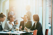 © Tom Merton/Caia Image - Smiling business people eating sushi lunch chopsticks in conference room meeting