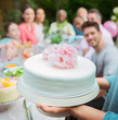 © Robert Daly/Caia Image - Close up white fondant cake with pink flowers