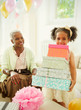 © Robert Daly/Caia Image - Portrait girl carrying stack of birthday gifts