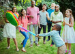 © Robert Daly/Caia Image - Multi-ethnic multi-generation family cheering boy hitting pinata at birthday party