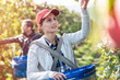 © Agnieszka Olek/Caia Image - Female farmer harvesting apples in sunny orchard