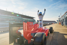 Formula One Race Car Driver Cheering On Sports Track, Celebrating Victory