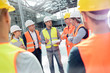© Agnieszka Olek/Caia Image - Foreman, engineers construction workers meeting at construction site