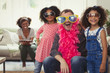 © Paul Bradbury/Caia Image - Portrait playful multi-ethnic father daughters playing dress up sunglasses feather boas